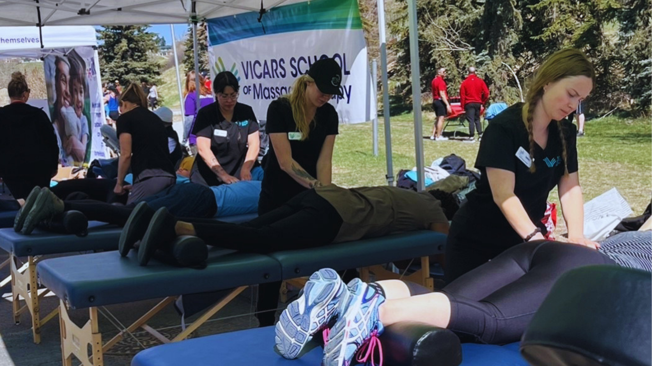 Vicars students offering massages to participants at the 2023 Steps to End Homelessness event, hosted by Inn from the Cold.
